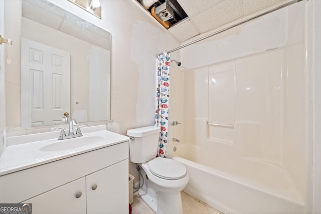 full bathroom featuring a paneled ceiling, toilet, shower / bath combo with shower curtain, vanity, and tile patterned floors