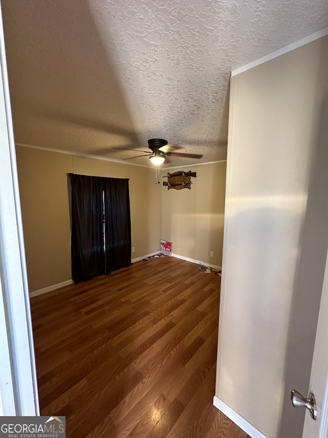 empty room with a textured ceiling, crown molding, hardwood / wood-style flooring, and ceiling fan