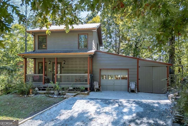 front of property featuring covered porch and a garage