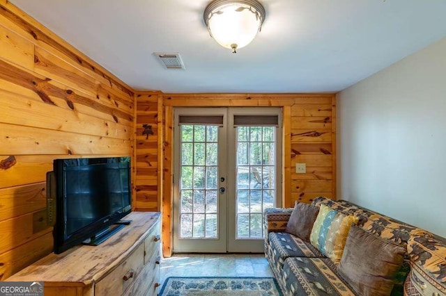 entryway featuring french doors and wood walls