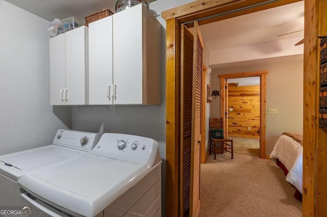 laundry area featuring cabinets, light colored carpet, washing machine and dryer, and ceiling fan