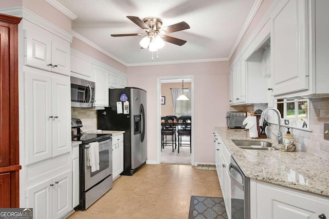 kitchen featuring white cabinets, tasteful backsplash, appliances with stainless steel finishes, crown molding, and sink