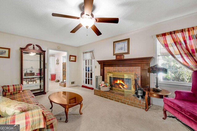 living room featuring light carpet, a textured ceiling, a brick fireplace, and ceiling fan