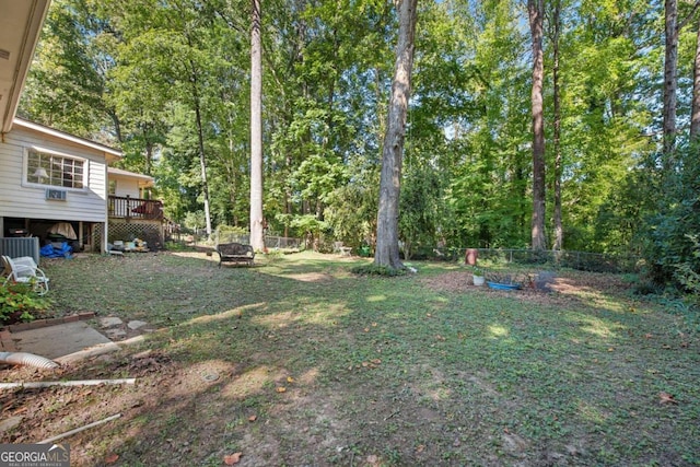 view of yard featuring an outdoor fire pit, cooling unit, and a deck