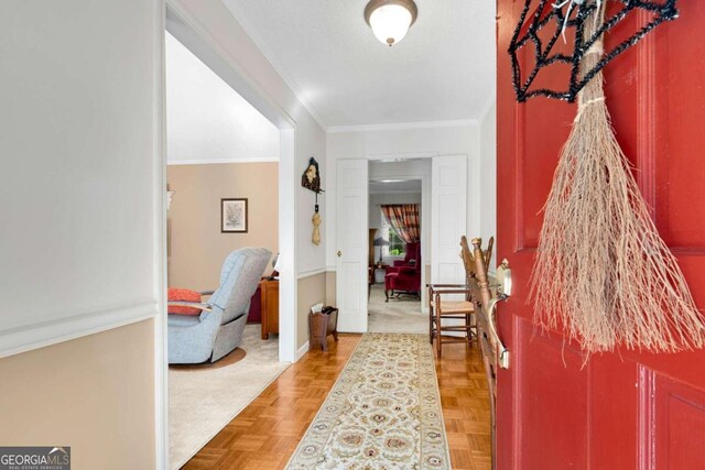 hallway with parquet flooring and crown molding