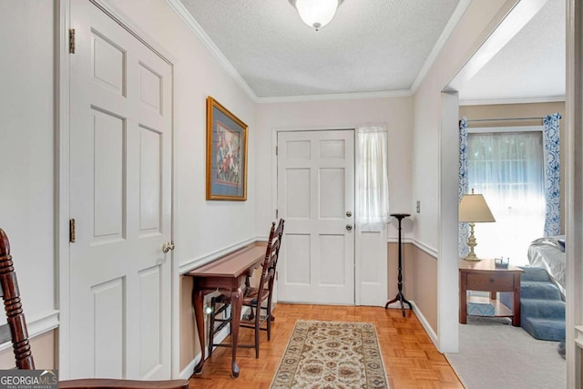 foyer featuring ornamental molding, a textured ceiling, and light parquet floors