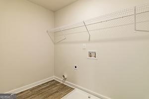 319 Brooks Dr Unit 73, Fairburn, GA 30213 - laundry area featuring electric dryer hookup, washer hookup, dark wood finished floors, and baseboards
