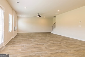 empty room with light hardwood / wood-style floors and ceiling fan