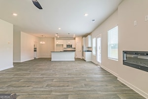 unfurnished living room with dark hardwood / wood-style floors