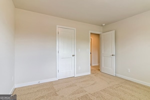 spare room with light colored carpet