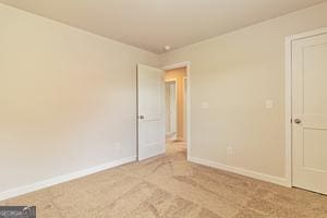 319 Brooks Dr Unit 73, Fairburn, GA 30213 - empty room featuring light carpet and baseboards