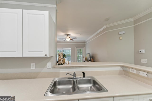 1517 Whitemarsh Way, Savannah, GA 31410 - kitchen with a sink, white cabinetry, crown molding, light countertops, and a ceiling fan