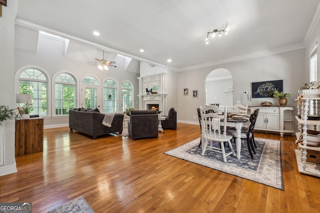 dining area with lofted ceiling, hardwood / wood-style floors, crown molding, and ceiling fan