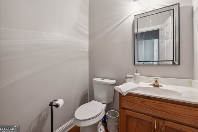 bathroom featuring vanity and toilet