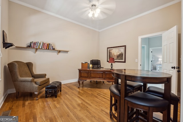 office space with light hardwood / wood-style floors, ornamental molding, and ceiling fan