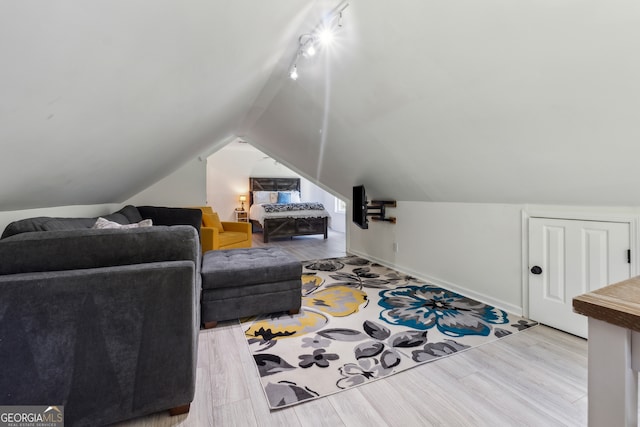 bedroom featuring lofted ceiling and light hardwood / wood-style flooring