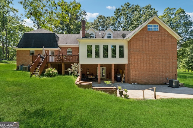 back of property with a patio, a wooden deck, central air condition unit, and a lawn