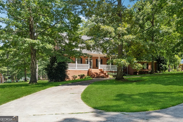 view of front of property with a front yard and covered porch