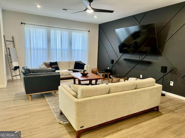 living room featuring ceiling fan and light wood-type flooring