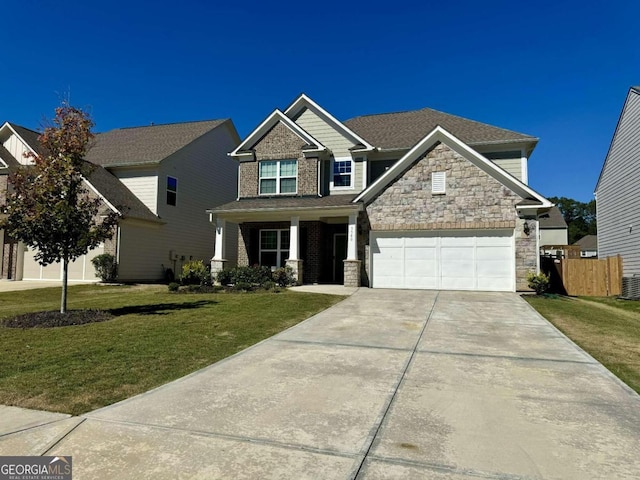 craftsman inspired home featuring a front yard and a garage