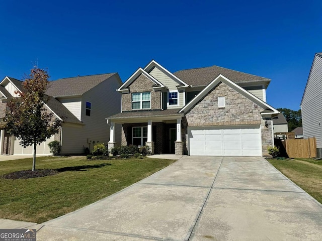 craftsman house with a front yard and a garage