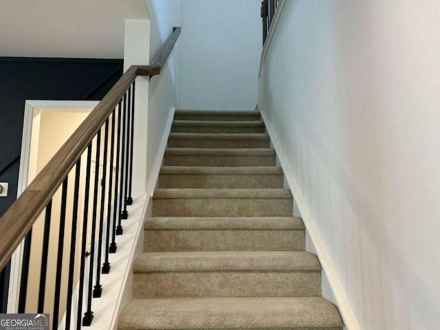 staircase with carpet floors