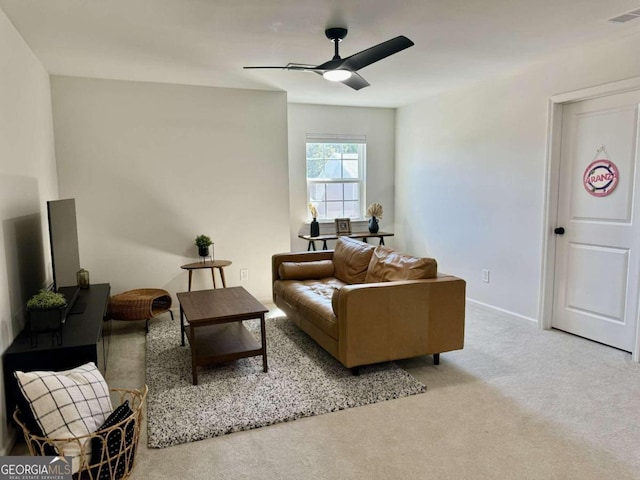 carpeted living room with ceiling fan