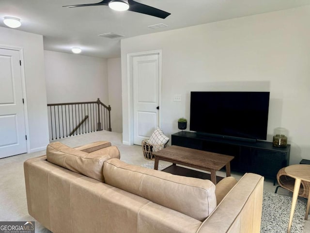 living room featuring light carpet and ceiling fan