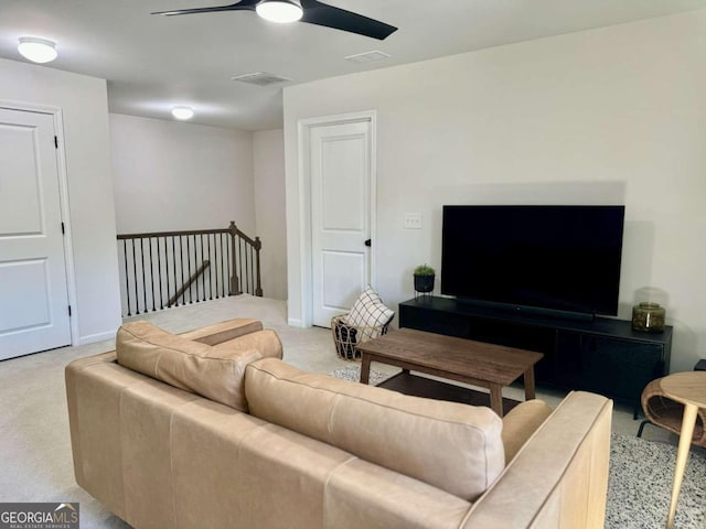 carpeted living room with ceiling fan