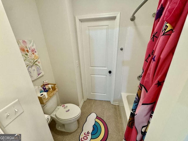 bathroom featuring toilet, shower / bath combo, and tile patterned floors