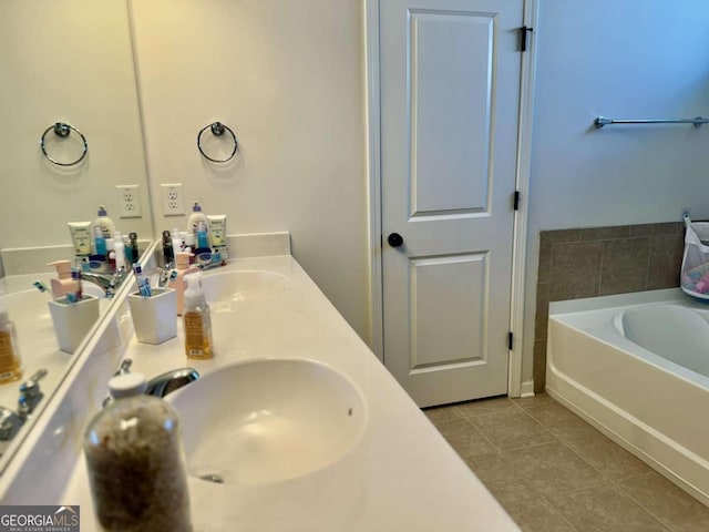 bathroom featuring vanity, a tub, and tile patterned flooring