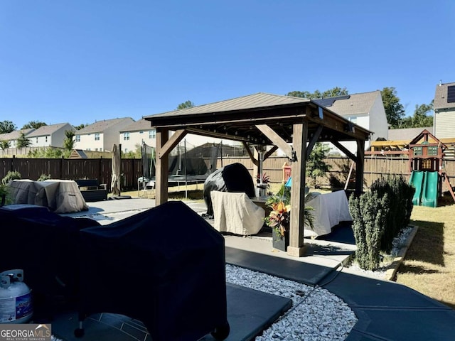 view of patio featuring a gazebo and a playground