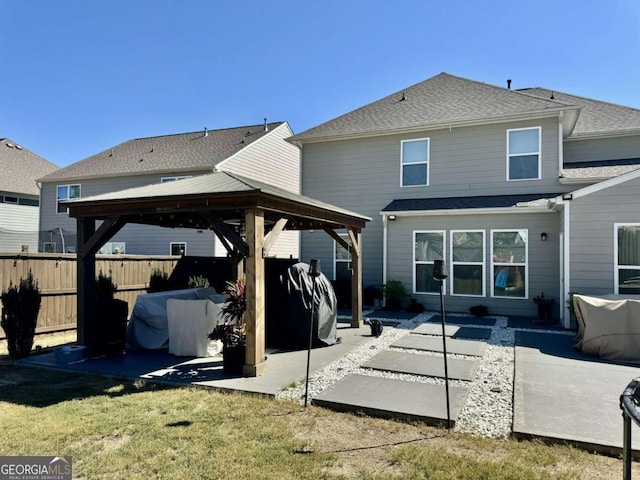 rear view of house featuring a patio, a gazebo, and a yard