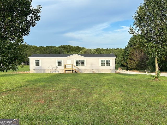 rear view of property with a lawn