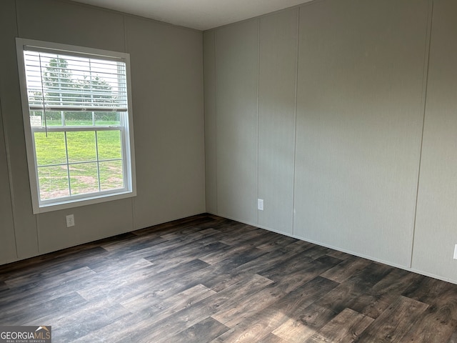 unfurnished room featuring dark hardwood / wood-style flooring