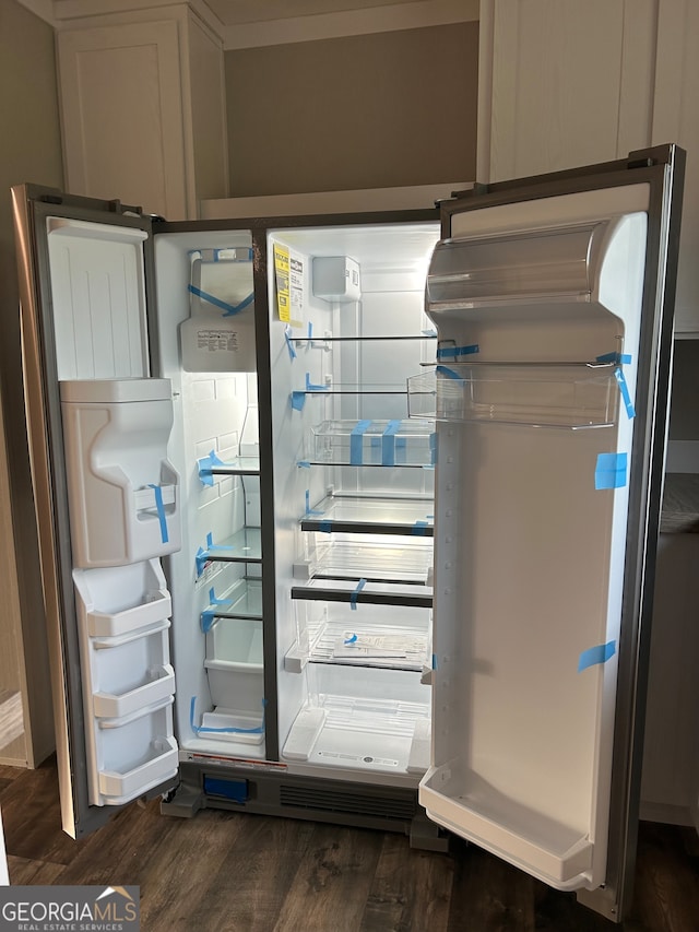 room details with dark wood-type flooring and white refrigerator