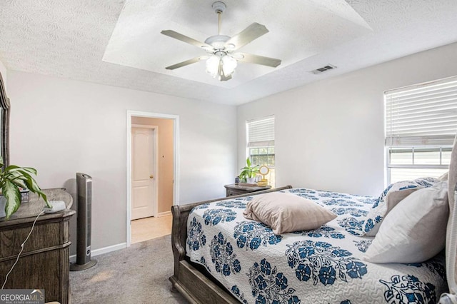 carpeted bedroom with a textured ceiling and ceiling fan