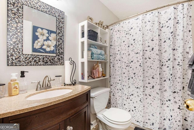 bathroom featuring toilet, a shower with shower curtain, and vanity