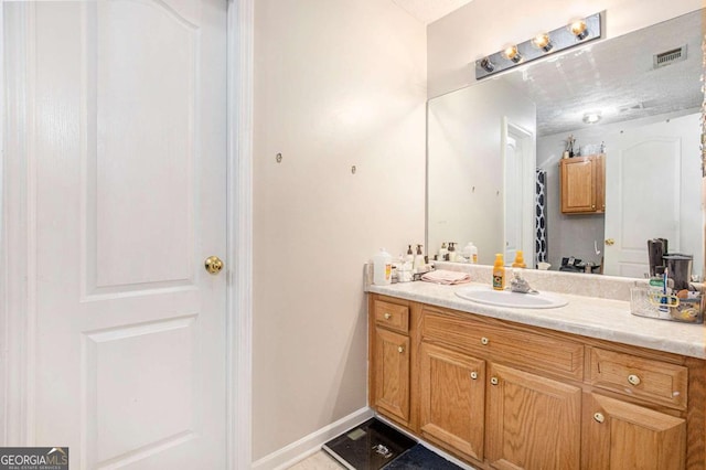 bathroom with tile patterned flooring and vanity