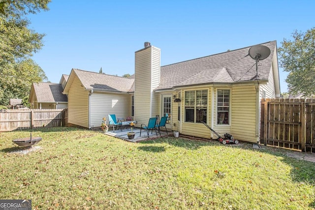 back of house featuring a yard and a patio area