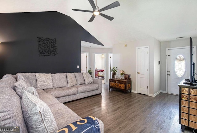 living room featuring ceiling fan, vaulted ceiling, and dark wood-type flooring