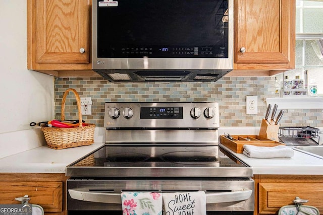 kitchen featuring stainless steel appliances and decorative backsplash