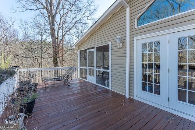 wooden terrace with a sunroom and french doors