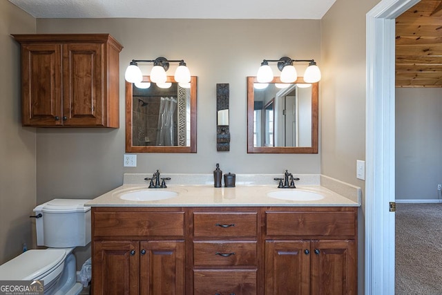 bathroom featuring toilet and vanity