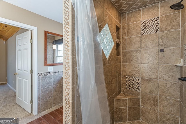 bathroom with a shower with curtain and hardwood / wood-style floors