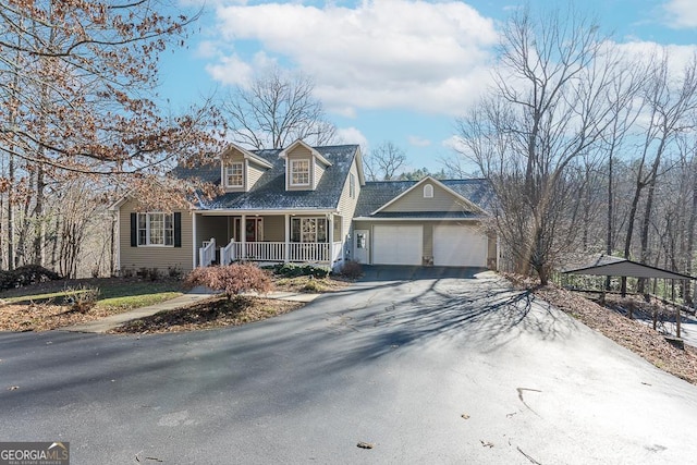 cape cod-style house with covered porch and a garage