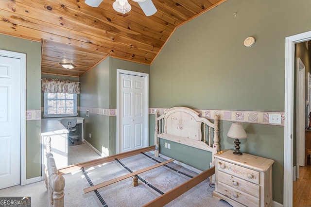 bedroom with ceiling fan, light colored carpet, vaulted ceiling, and wooden ceiling