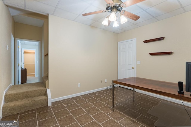 office featuring a paneled ceiling and ceiling fan