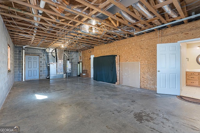 basement featuring heating unit and water heater