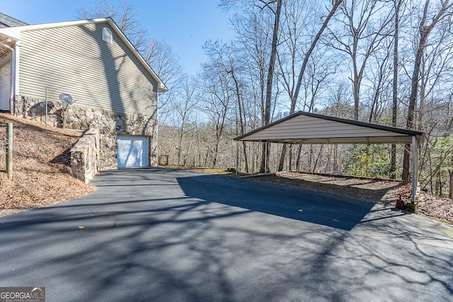 view of property exterior with a carport and a garage